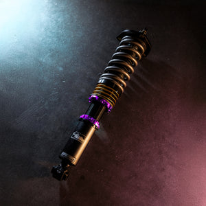 Coilover suspension part laying on concrete floor purple elements